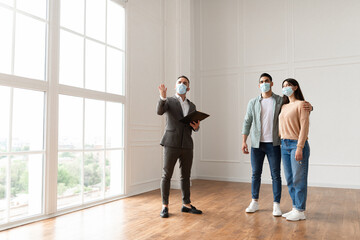 Wall Mural - Estate Agent In Medical Mask Showing Buyers New Apartment