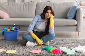 Wall Mural - Upset woman tired of cleaning sitting on floor