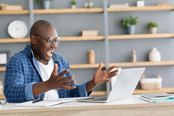 Business success. Overjoyed african american male entrepreneur emotionally celebrating achievement