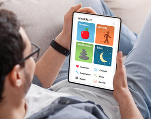 Aufkleber - Young man enjoying brand new health app on tablet