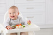 © New Africa - Cute little baby eating healthy food at home. Space for text