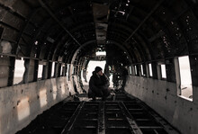Man Sitting In Cabin Of Crashed Broken Aircraft