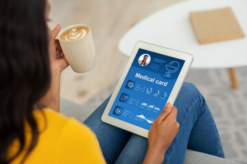 Aufkleber - Black lady checking her medical card online, using pad