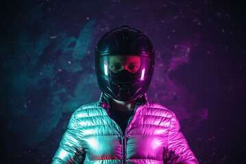 Wall Mural - A portrait of motorbiker in the helmet in the neon lights.