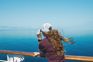 Woman standing and looking on the sea level from ferry boat. 