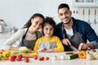 © Prostock-studio - Portrait Of Happy Middle Eastern Family With Little Daughter Cooking In Kitchen