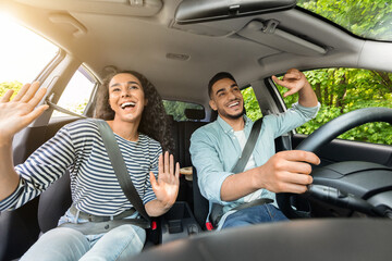 Emotional mixed race couple having fun while car trip