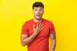 © luismolinero - Young caucasian handsome man isolated on yellow background surprised and shocked while looking right