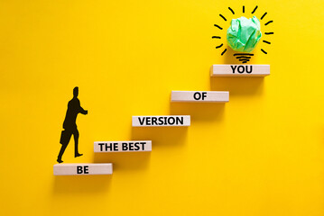 Wall Mural - Best version of you symbol. Wooden blocks with words Be the best version of you on yellow background, copy space. Businessman icon, light bulb. Business, best version of you concept.