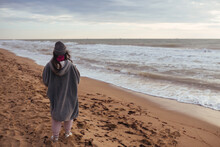 Young Woman On Cold Autumn Seashore Posing At Camera