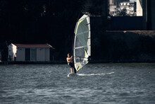 Windsurfer Surfing On A Windy Day At The City River.