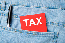The Back Pocket Of Blue Jeans Contains A White Pen And A White Red Card With The Text TAX