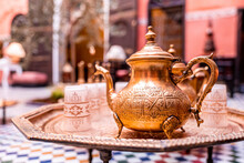 Close Up Of Decorative Ancient Metal Teapot With Cups On Table
