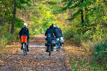 Amish Family Riding Bikes In Autumn