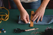 © Julia - Seamstress marking jeans length for hemming