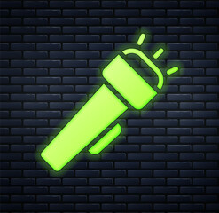 Sticker - Glowing neon Flashlight icon isolated on brick wall background. Vector