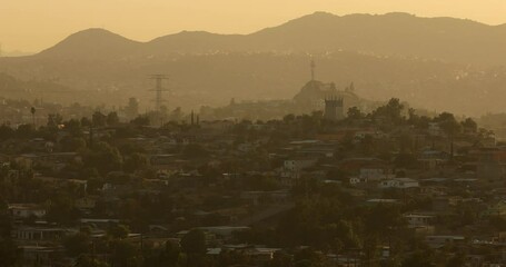 Wall Mural - Tecate, Baja California, Mexico - September 14, 2021: Late afternoon sun shines on a bustling downtown Tecate.