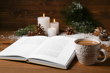 Wall Mural - Cup of tasty coffee, book and Christmas decor on wooden background