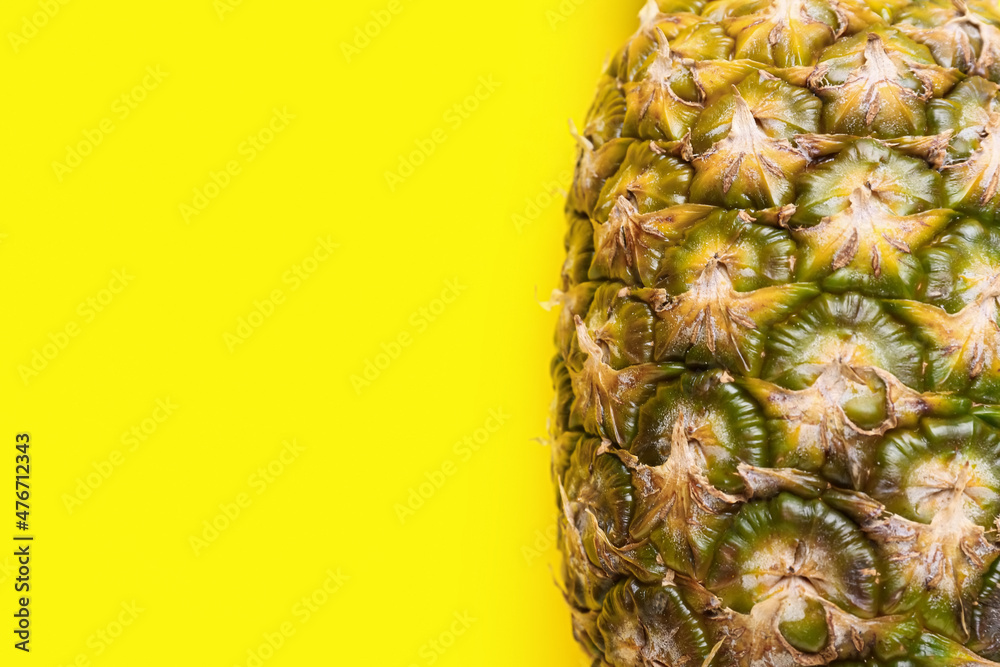 Fresh pineapple on yellow background, closeup