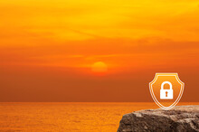 Padlock With Shield Flat Icon On Rock Mountain Over Sunset Sky And Sea, Technology Security Insurance Concept