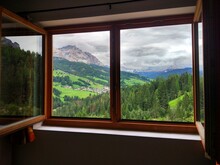 View Through The Window On The Dolomites Mountains And Forest Landscape