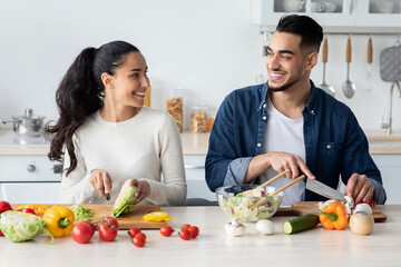 Wall Mural - Young Arab Spouses Cooking Healthy Lunch Together In Kitchen At Home