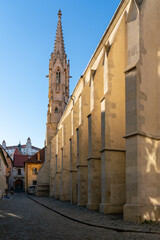 Wall Mural - Gothic church of light stone with buttress walls, St Claire Monastery with Bratislava Castle in background