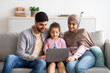 © Prostock-studio - Cheerful muslim family having fun with laptop, surfing internet, playing games or having video chat, sitting on sofa