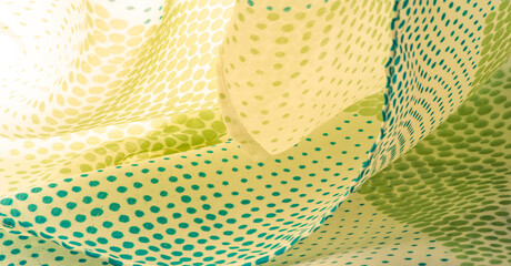 silk fabric. Blue and green pattern with polka dots on a beige b