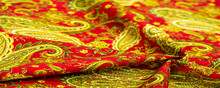 Paisley Green Pattern On A Red Background. Decorated The Bandanas Of Cowboys And Bikers Popularized By The Beatles, Ushered In The Era Of Hippies And Became The Emblem Of Rock And Roll.