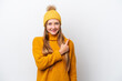 © luismolinero - Young caucasian woman wearing winter jacket isolated on white background pointing to the side to present a product