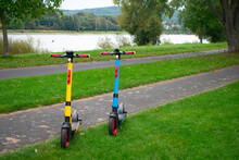 Colorful Electric Scooters In Green City Park – Bonn Germany. European Energy Transition Motif