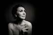© Igor Borodin - Portrait of a sensual fifty year old woman on grey studio background. Monochrome shot.