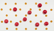 New Year Party Concept Background Made Of Gold Confetti And Red Baubles. Minimal Concept Wallpaper. Flat Lay Holiday Idea,