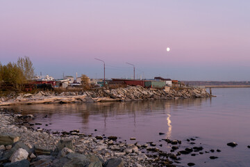 Rocky shore and quiet sea surface at sunset.