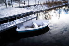 Small Boat In The Center Of The Lake Of A Snow-covered Park