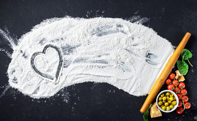 Aufkleber - Ingredients for cooking a delicious Italian dish with a heart on flour, top view. Abstract baking background
