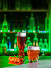 Mugs of green beer, ale on the bar counter. Holiday of Ireland on St. Patrick's Day in irish pub, bar. Festive Leprikon's green hat. National tradition of carnival celebrating March 17