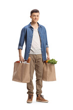 Full Length Portrait Of A Guy Carrying Grocery Bags