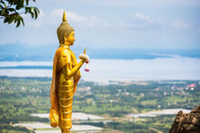 Lop Buri,Thailand - October, 07, 2021 :The Golden Buddha Statue Standing On The Edge Of The Cliff Is The Landmark Of Khao Phraya Dern Thong Viewpoint At Lopburi Thailand.