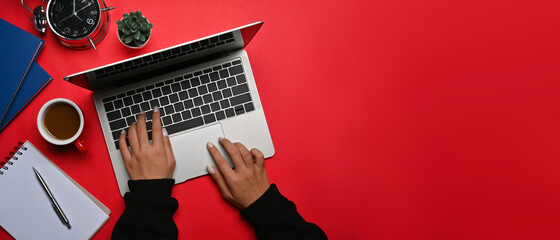 Above view creative woman using computer laptop on red background.