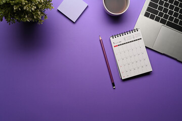 Fototapete - Top view calendar, laptop computer and coffee cup on purple background.