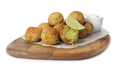 Delicious falafel balls with lime and sauce on white background