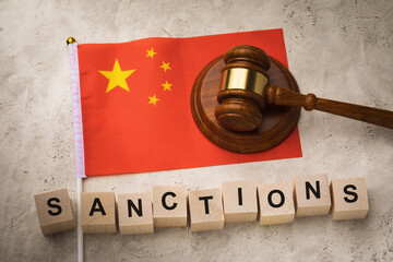 Wall Mural - Wooden cubes with the text, the judge gavel and the flag of China, a concept on the theme of the imposed sanctions in the country