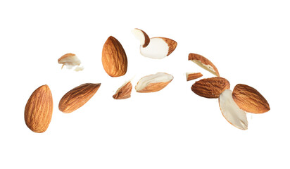 Pieces of tasty almonds falling on white background