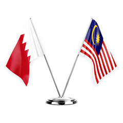 Two table flags isolated on white background 3d illustration, bahrain and malaysia