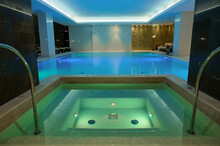 Thermal Swimming Pool With Underwater Illuminations And Waterfall In Luxury Hotel Spa Center