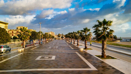 Canvas Print - Aerial view of Mazara del Vallo city promenade along the ocean, beautiful coast of Sicily at sunset from drone.