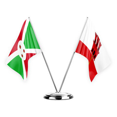 Two table flags isolated on white background 3d illustration, burundi and gibraltar