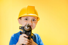 Smiling Boy Builder In A Blue Shirt Holding A Drill